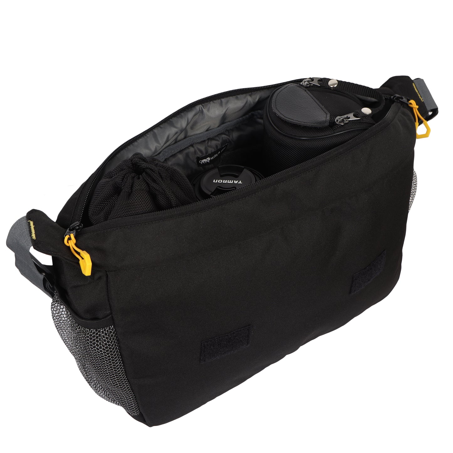 Top view of the 'Load Runner' sling bag at a 45-degree angle, with the top zipper open and lenses neatly stacked inside. The bag's design allows for secure and organized storage of up to 4 lenses. The open zipper reveals the convenient accessibility and thoughtful organization of the lenses, making it easy for photographers to quickly switch between different focal lengths.